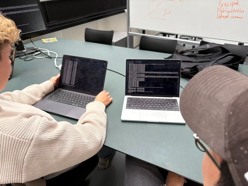 Students working with training logs on laptops during the course